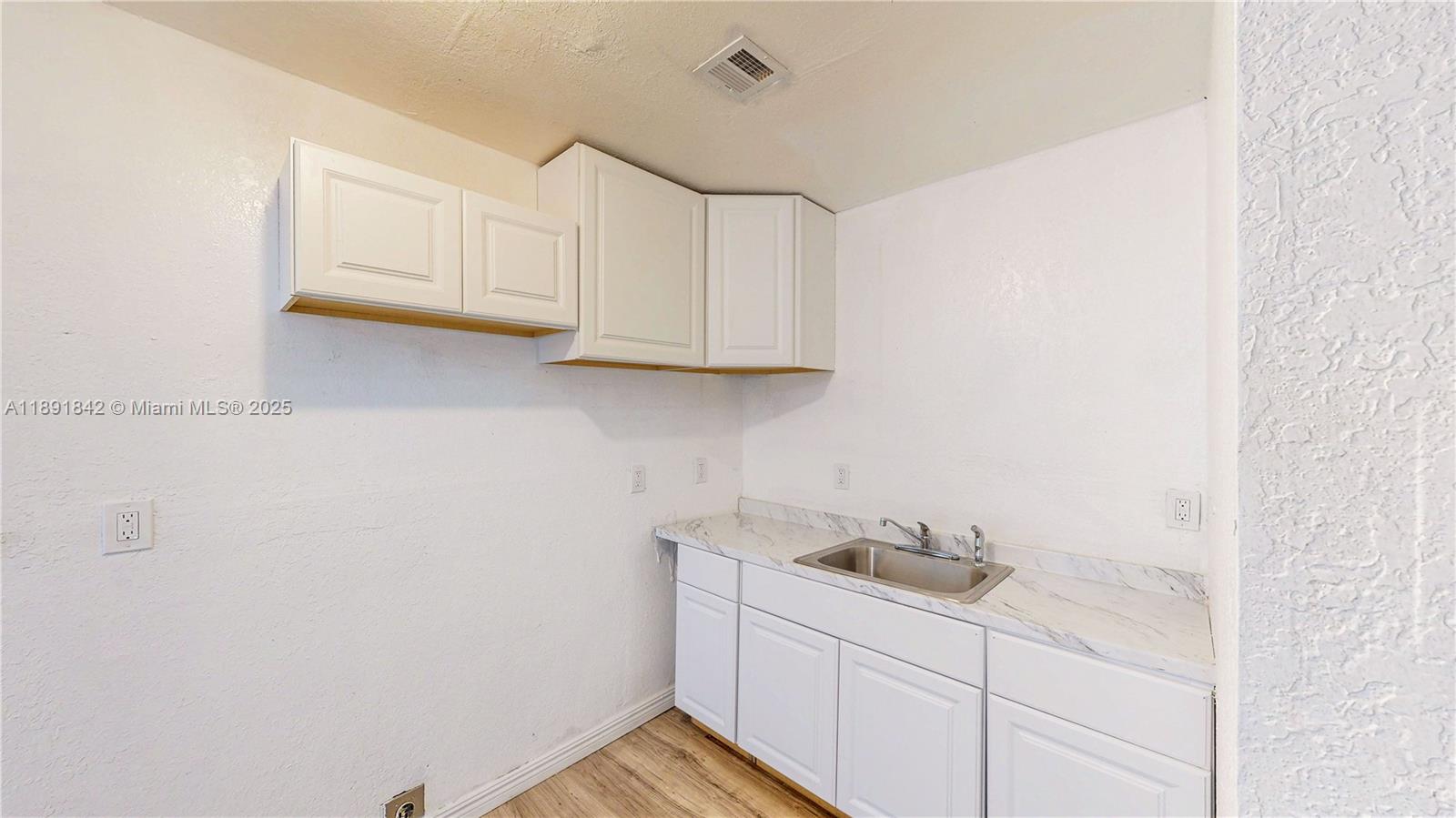 22230 Southwest 115th Court Miami, FL 33170 - Photo 10 of 63 a bathroom with a sink and cabinets
