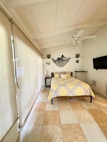 a bedroom with a bed and a mirror