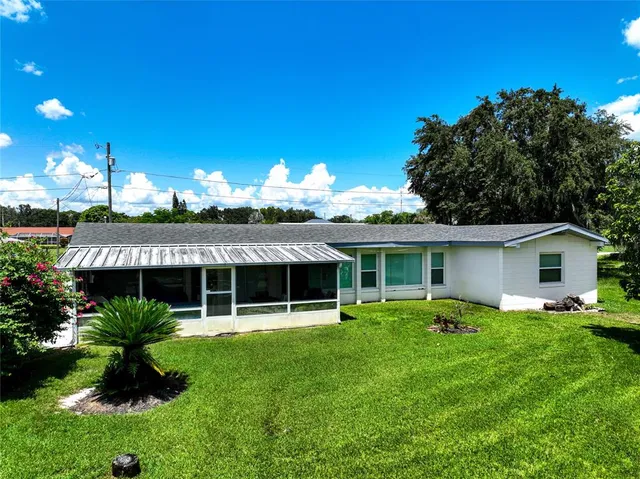 a view of a house with a yard porch and sitting area