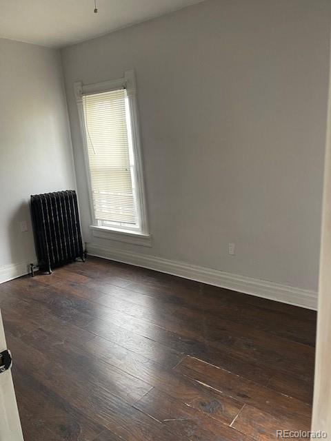 326 Cedar Street Wray, CO 80758 - Photo 12 of 19 an empty room with wooden floor and a window