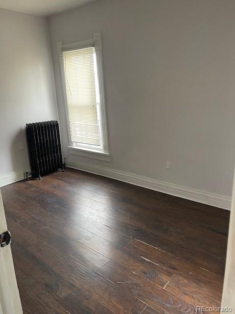 326 Cedar Street Wray, CO 80758 - Photo 13 of 19 an empty room with wooden floor and windows
