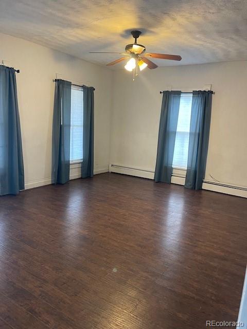 326 Cedar Street Wray, CO 80758 - Photo 4 of 19 wooden floor in an empty room with a window