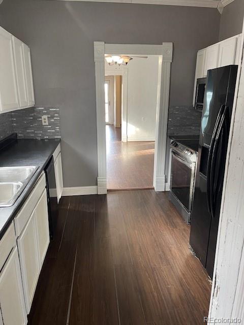 326 Cedar Street Wray, CO 80758 - Photo 6 of 19 an empty room with wooden floor and a refrigerator
