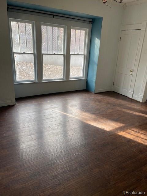 326 Cedar Street Wray, CO 80758 - Photo 8 of 19 an empty room with wooden floor and windows