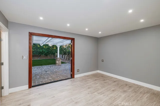 a view of a big room with wooden floor and front door