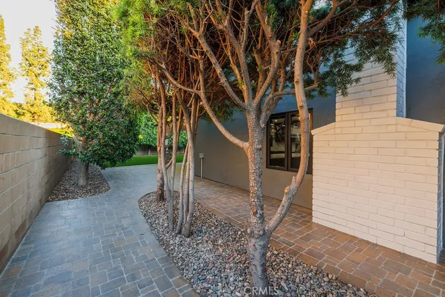 a view of a house with a tree and a yard
