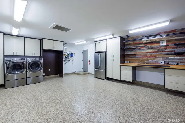 a kitchen with stainless steel appliances granite countertop a refrigerator and a stove top oven