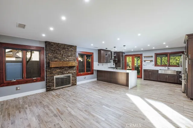 a view of kitchen with kitchen island sink and refrigerator