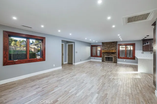 a view of work space with wooden floor and windows