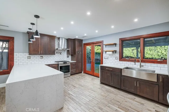 a large kitchen with stainless steel appliances lots of counter top space