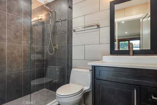 a bathroom with a toilet a sink and shower