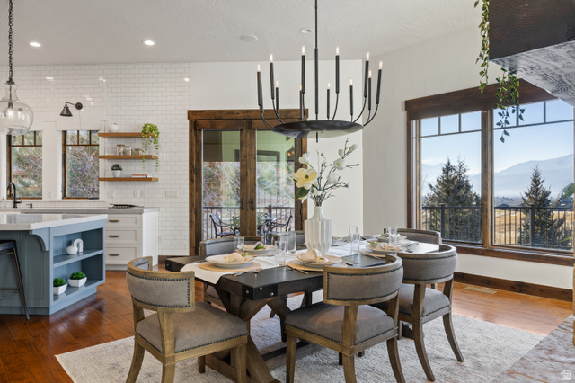 707 Chimney Rock Road, Unit 247 Heber City, UT 84032 - Photo 11 of 64 Dining room with french doors, dark wood-type flooring, a mountain view, a textured ceiling, and recessed lighting