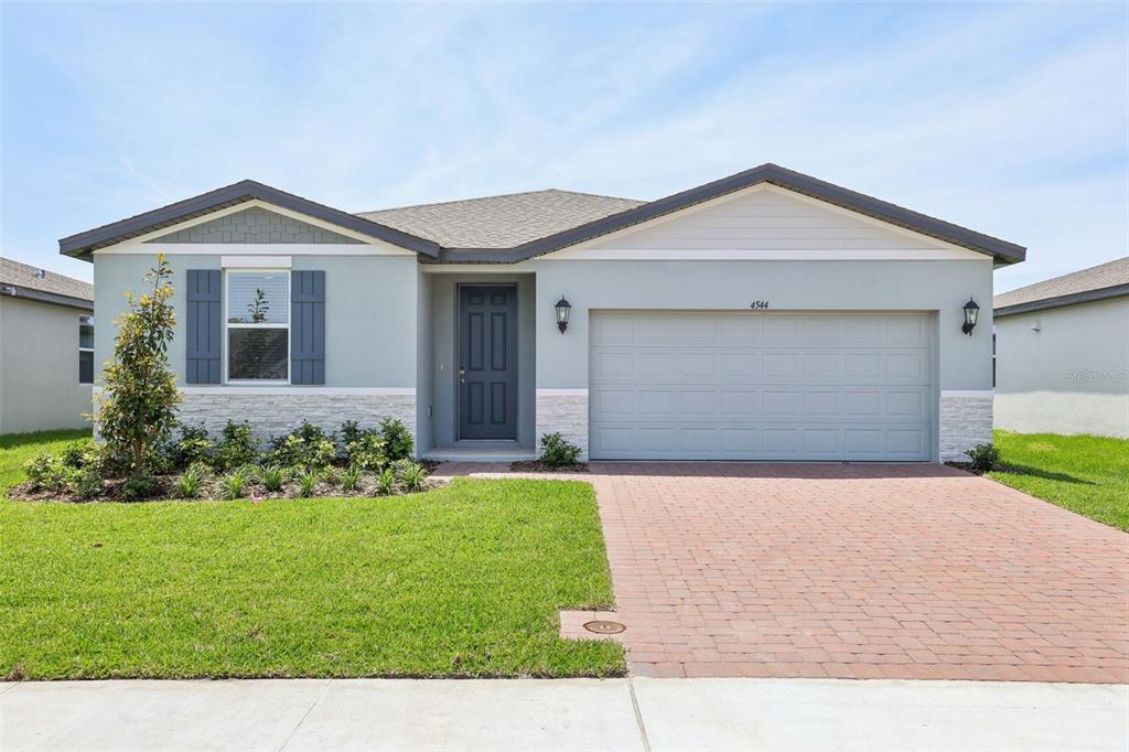 4544 Windy Oak Way St. Cloud, FL 34772 - Photo 1 of 1 a front view of a house with a yard and garage