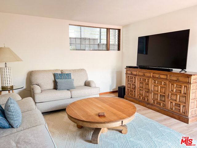 a view of a dining room with furniture and a floor to ceiling window