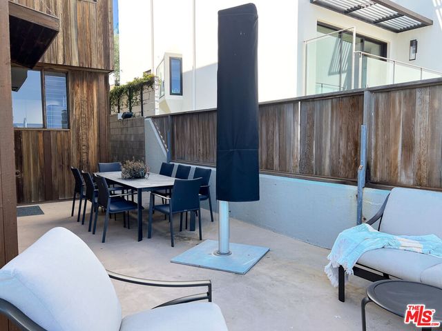 a room with lots of white walls and a floor to ceiling window