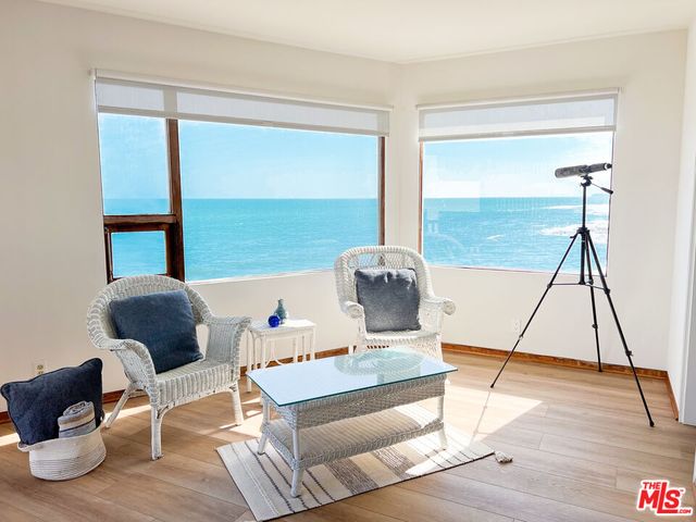 a balcony with table and chairs