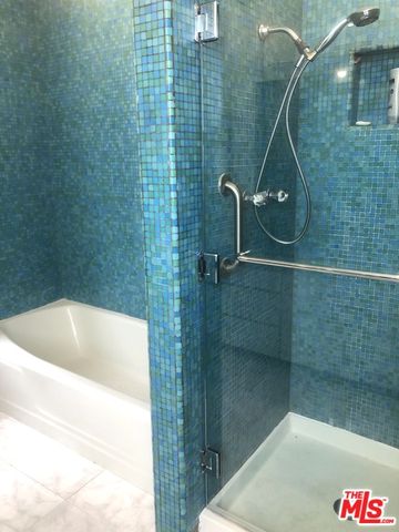 a bathroom with a bathtub and shower