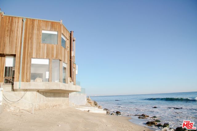 a vase of flowers sitting on a floor