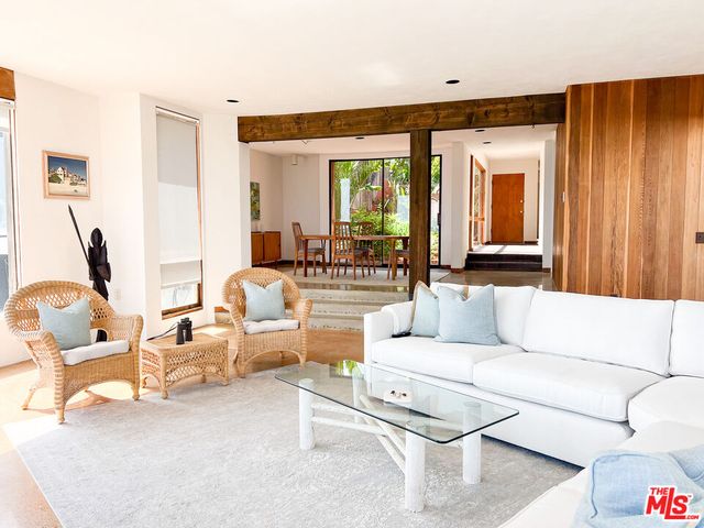 a living room with furniture and large windows