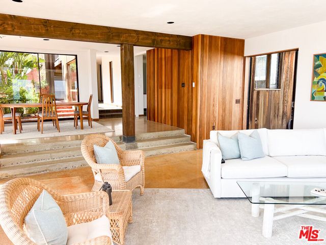 a living room with furniture and large windows