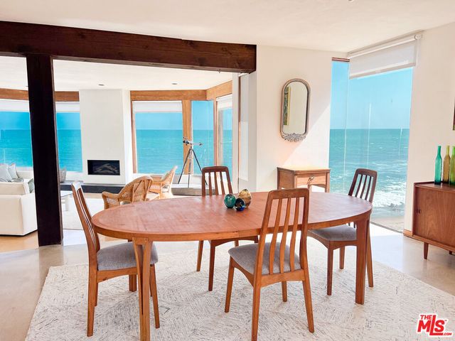 a dining room with furniture a rug and wooden floor