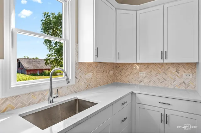 a kitchen with a sink and cabinets