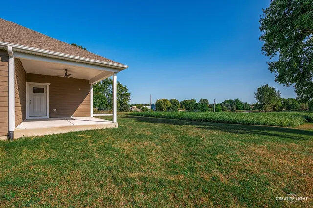 a view of a house with backyard sitting area and garden