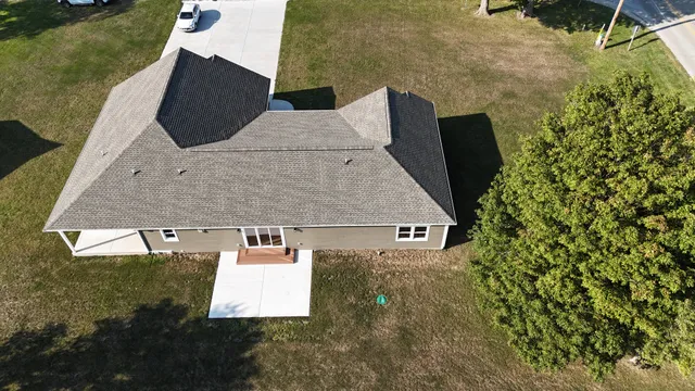 aerial view of a house with a yard