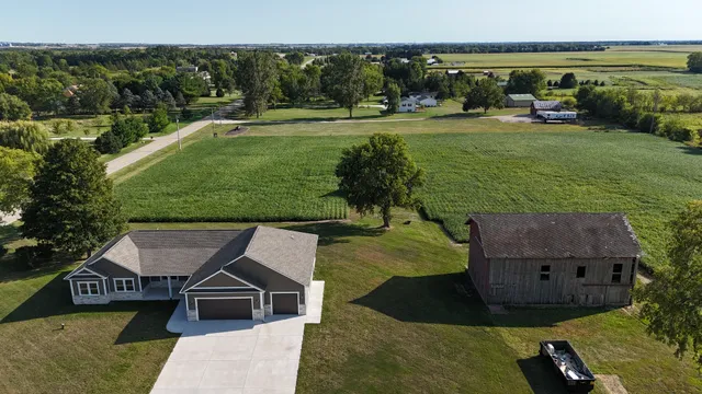 an aerial view of a house with garden space and street view