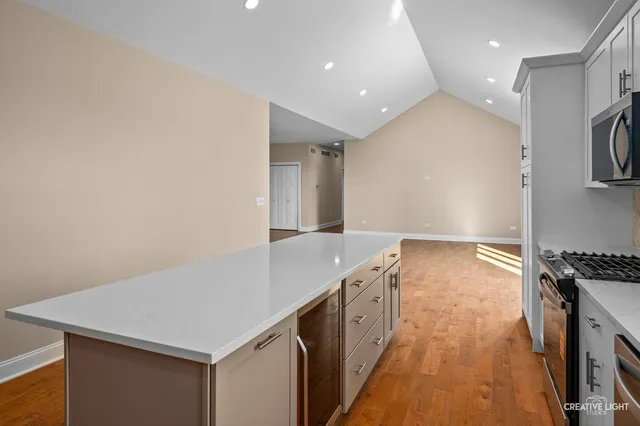 a kitchen with granite countertop a sink and a stove top oven