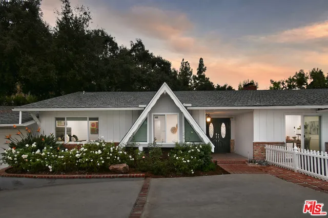 a living room with furniture fireplace and flat screen tv