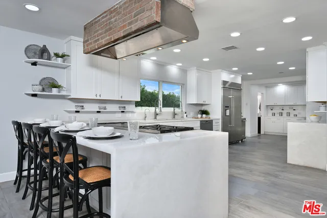a bathroom with a granite countertop bathtub shower sink and vanity