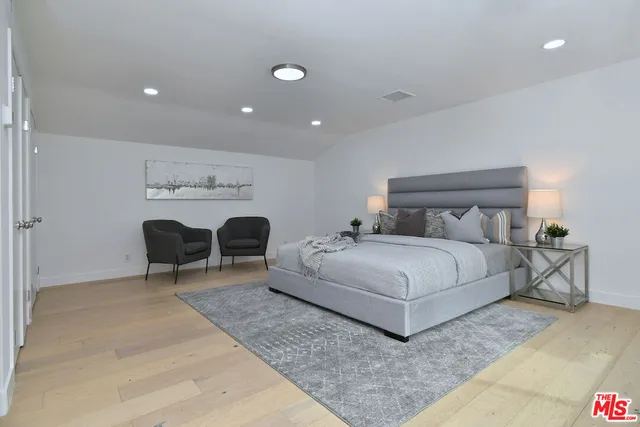 a bedroom with a large bed and a window