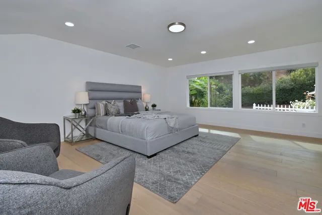 a bedroom with a large bed and a couch