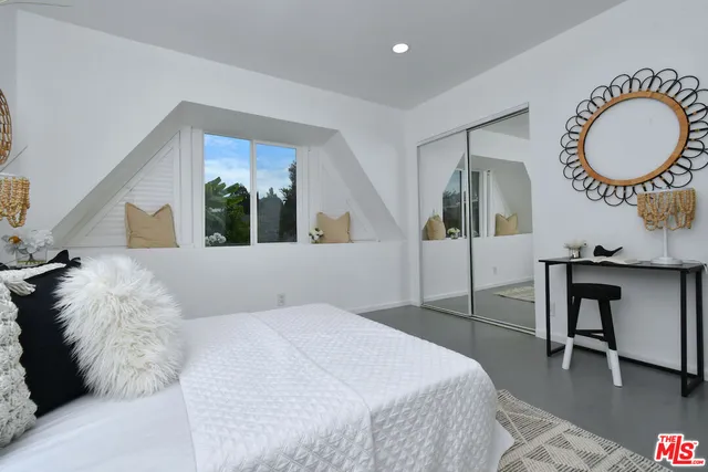 a view of a patio with chairs and potted plants