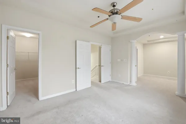 a view of empty room with ceiling fan