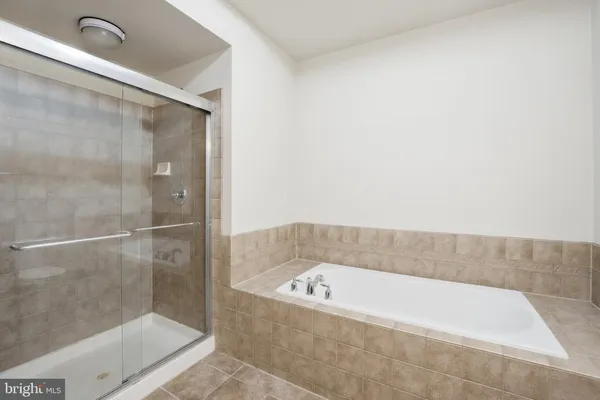 a bathroom with a bathtub and shower