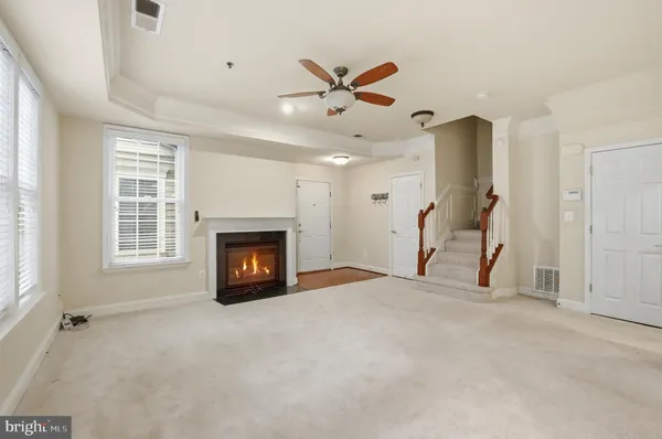 a view of an empty room with a fireplace and a window