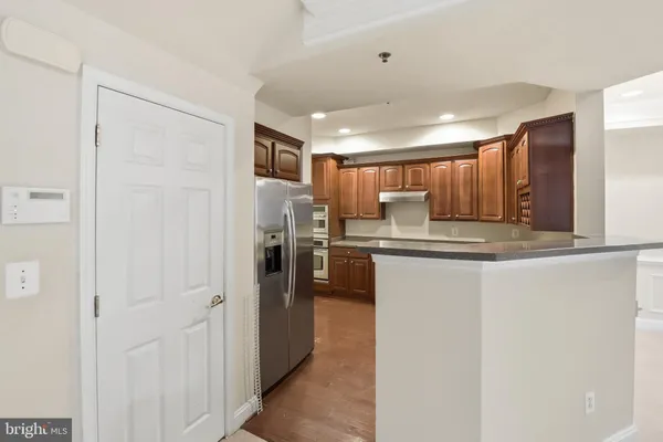 a kitchen with refrigerator and cabinets