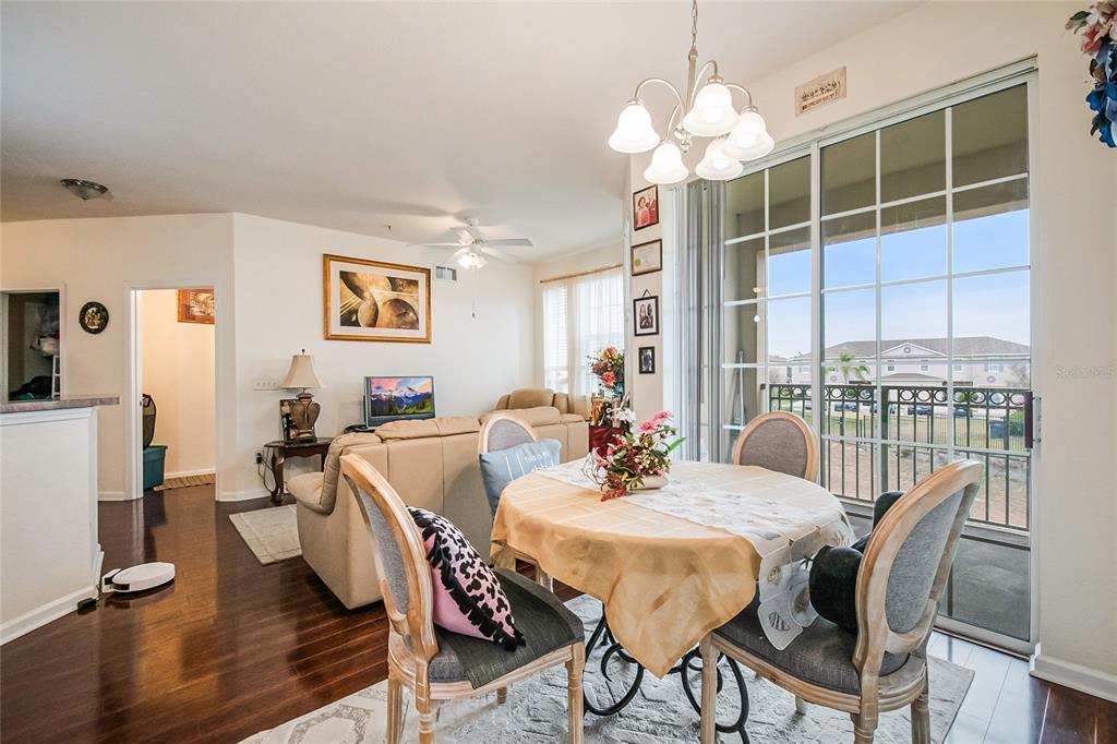 612 Terrace Ridge Circle, Unit 612 Davenport, FL 33896 - Photo 20 of 45 a view of a dining room with furniture window and wooden floor