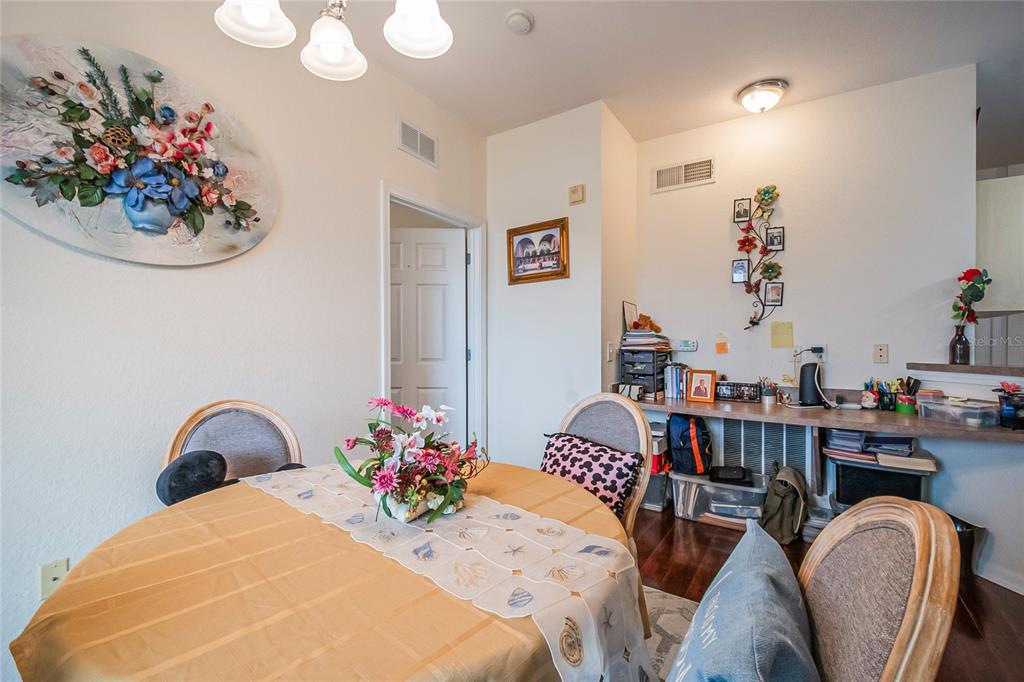 612 Terrace Ridge Circle, Unit 612 Davenport, FL 33896 - Photo 22 of 45 a bedroom with a bed and a chandelier