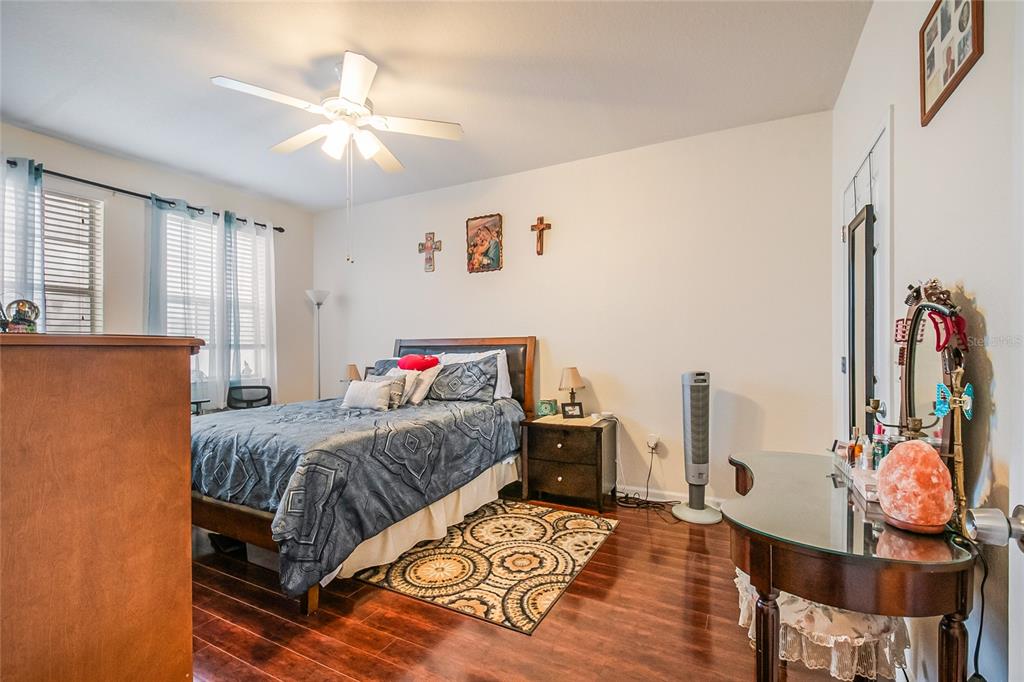 612 Terrace Ridge Circle, Unit 612 Davenport, FL 33896 - Photo 23 of 45 a bedroom with a bed and wooden floor