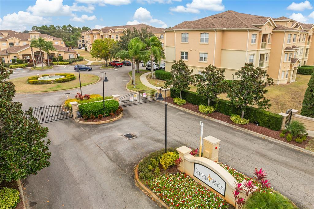 612 Terrace Ridge Circle, Unit 612 Davenport, FL 33896 - Photo 38 of 45 a view of a chair and tables in the patio