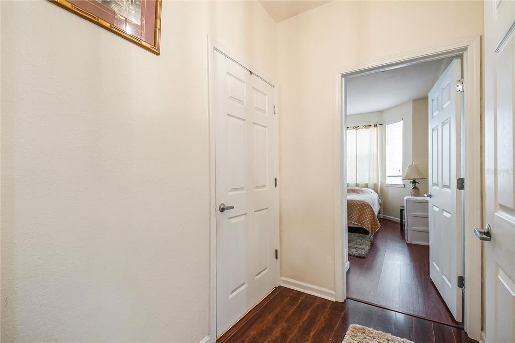 612 Terrace Ridge Circle, Unit 612 Davenport, FL 33896 - Photo 7 of 45 a view of a hallway with wooden floor windows and a bathroom