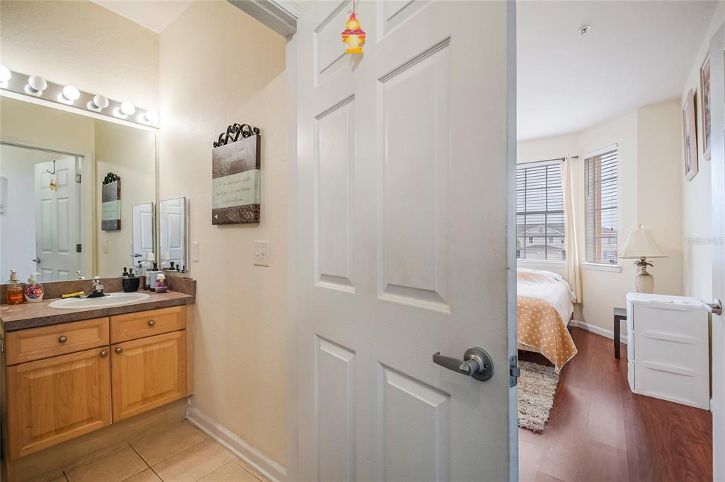 612 Terrace Ridge Circle, Unit 612 Davenport, FL 33896 - Photo 10 of 45 a en suite bathroom with a granite countertop sink and a mirror