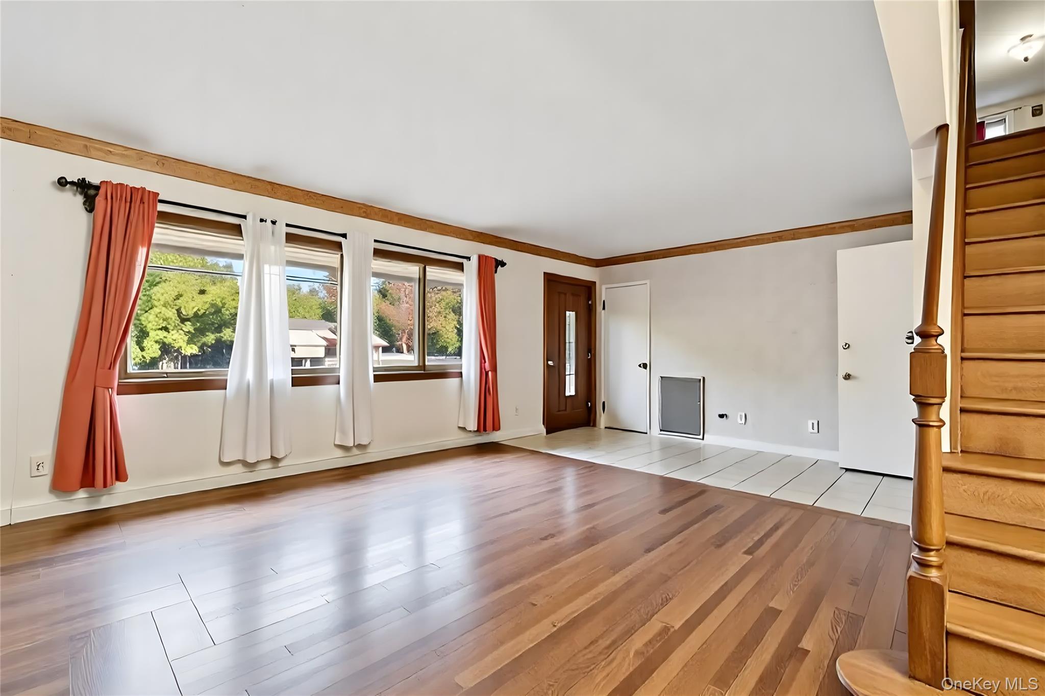 738 Old Town Road Port Jefferson Station, NY 11776 - Photo 6 of 28 a view of an empty room with wooden floor and a window