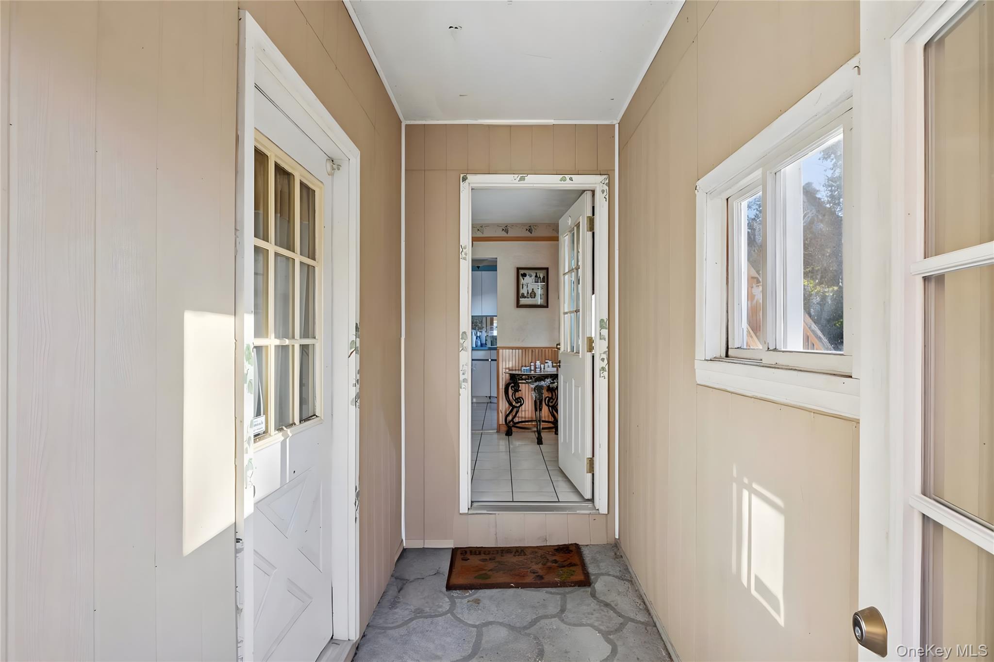 738 Old Town Road Port Jefferson Station, NY 11776 - Photo 9 of 28 a view of a hallway with windows and entryway