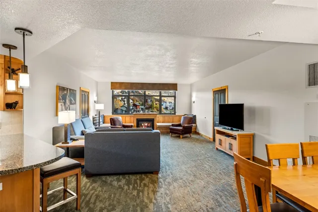 a living room with furniture and a dining table