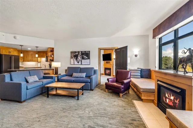 a kitchen with stainless steel appliances granite countertop a sink refrigerator and cabinets