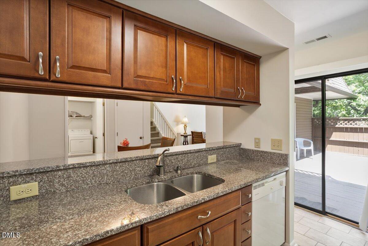 163 Springberry Lane Chapel Hill, NC 27517 - Photo 7 of 32 a kitchen with granite countertop a sink and a window